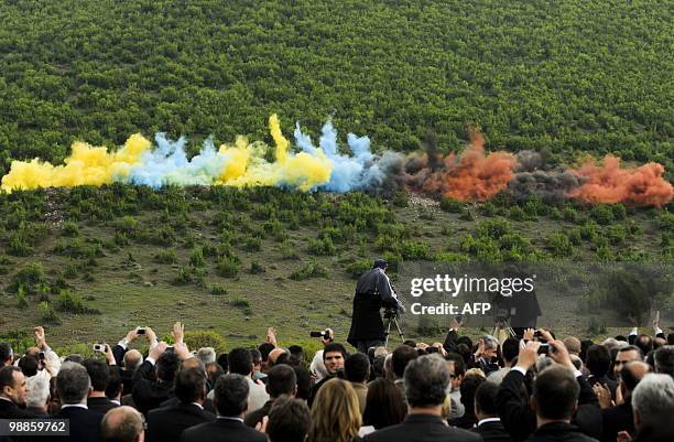 Kosovo Albanians watch a "solemn" explosion symbolically ignited by Kosovo's Prime Minister Hashim Thaci as they attend a ceremony on April 25 in the...