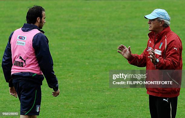 Italy's coach Marcello Lippi talks to forward Giampaolo Pazzini during a training session of the italian national team on the outskirts of Rome on...