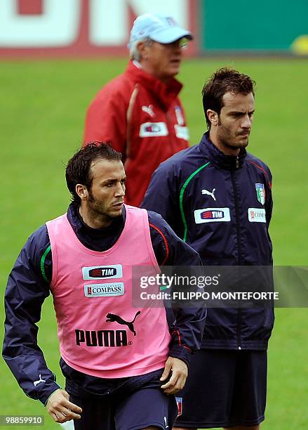 Italy's coach Marcello Lippi stands between forwards Giampaolo Pazzini and Alberto Gilardino during a training session of the Italian national team...