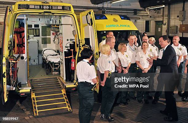 British opposition Conservative party Leader David Cameron talks to ambulance personnel during an election campaign visit on May 5, 2010 in Dudley,...