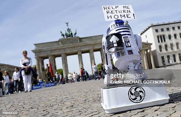The robot R2D2 from the Star Wars movies collects money for his journey home in front of the Brandenburg Gate in Berlin on May 5, 2010. The...