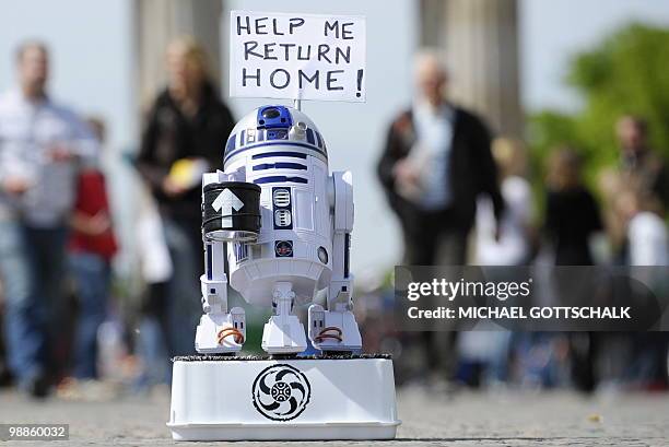 The robot R2D2 from the Star Wars movies collects money for his journey home in front of the Brandenburg Gate in Berlin on May 5, 2010. The...