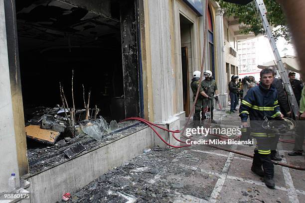 Greek riot police secure the entrance of the Marfin Egnatia Bank where 3 people died after protesters set fire to the building, on May 5, 2010 in...