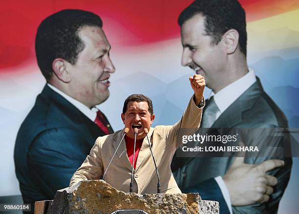 Venezuelan President Hugo Chavez raises his fist as he addresses crowds in Sweida, 100 kms south of Damascus, on Septamber 4, 2009. Chavez visited...