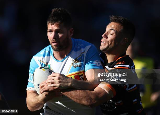 Anthony Don of the Titans is tackled during the round 16 NRL match between the Wests Tigers and the Gold Coast Titans at Leichhardt Oval on July 1,...