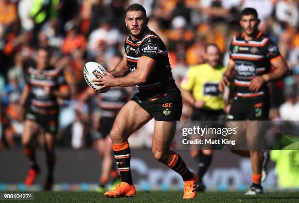 Robbie Farah of the Tigers runs with the ball during the round 16 NRL match between the Wests Tigers and the Gold Coast Titans at Leichhardt Oval on...