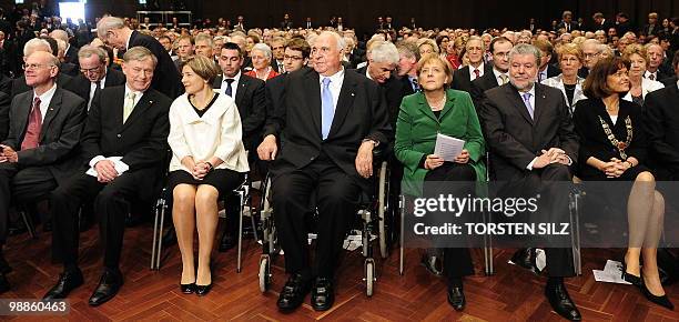 German Chancellor Angela Merkel sits next to former German Chancellor Helmut Kohl during an official birthday reception for Kohl in his hometown of...