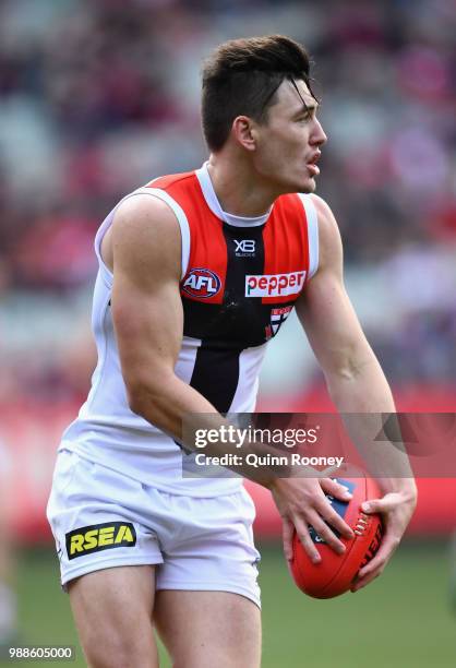 Josh Battle of the Saints kicks during the round 15 AFL match between the Melbourne Demons and the St Kilda Saints at Melbourne Cricket Ground on...