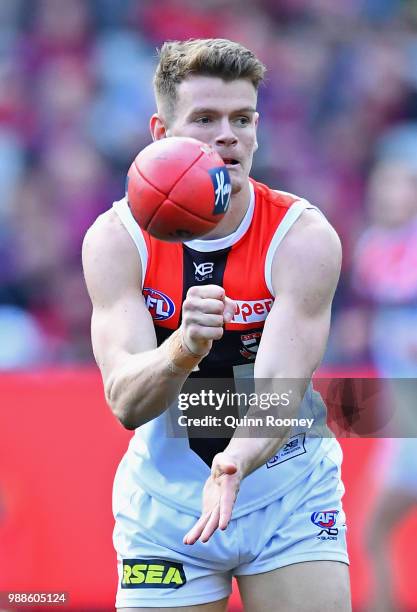 Darragh Joyce of the Saints handballs during the round 15 AFL match between the Melbourne Demons and the St Kilda Saints at Melbourne Cricket Ground...