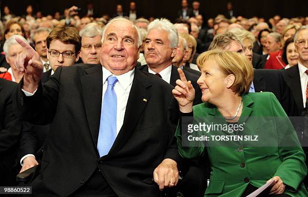 German Chancellor Angela Merkel chats with former German Chancellor Helmut Kohl during an official birthday reception for Kohl in his hometown of...