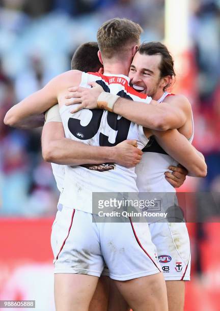 Jarryn Geary, Darragh Joyce and Daniel McKenzie of the Saints celebrate winning the round 15 AFL match between the Melbourne Demons and the St Kilda...