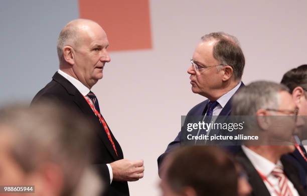 Brandenburg's SPD party chairman and premiere Dietmar Woidke speaks with Lower Saxony's premiere Stephan Weil before the start of the SPD federal...