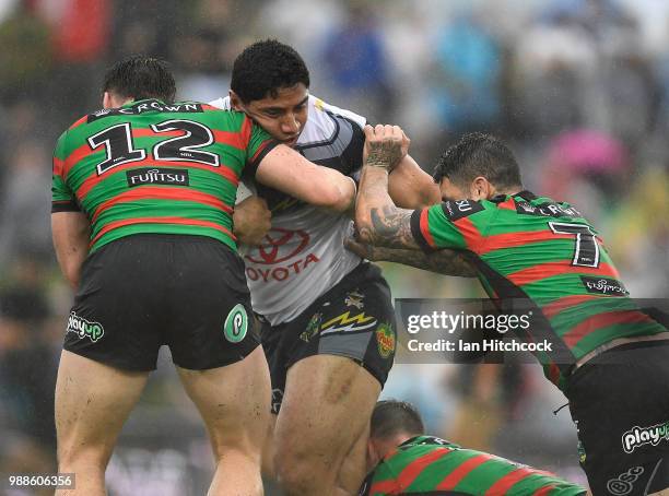 Jason Taumalolo of the Cowboys is tackled by Angus Crichton and Adam Reynolds of the Rabbitohs during the round 16 NRL match between the South Sydney...