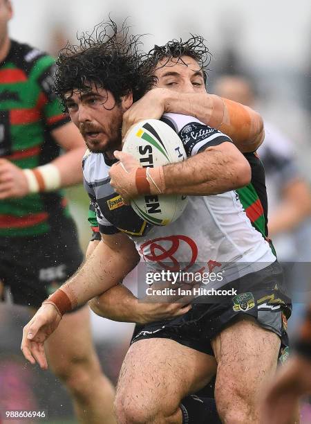 Jake Granville of the Cowboys is tackled during the round 16 NRL match between the South Sydney Rabbitohs and the North Queensland Cowboys at Barlow...