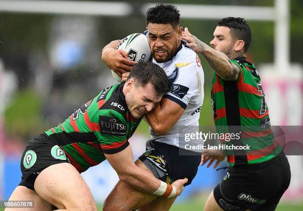 Antonio Winterstein of the Cowboys is tackled by Angus Crichton and Adam Reynolds of the Rabbitohs during the round 16 NRL match between the South...