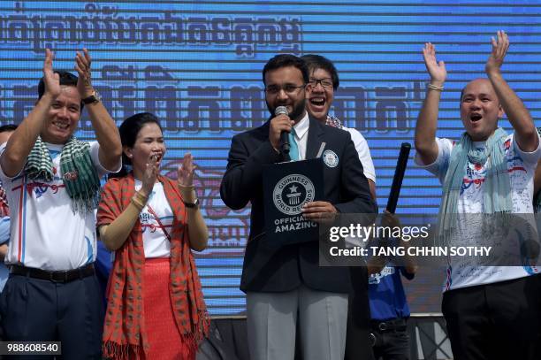 Official from the Guinness World Records adjudicator Swapnil Dangarikar makes an announcement as Hun Many , son of Cambodian Prime Minister Hun Sen,...