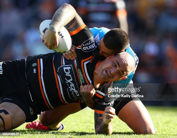 Russell Packer of the Tigers is tackled by Titans during the round 16 NRL match between the Wests Tigers and the Gold Coast Titans at Leichhardt Oval...