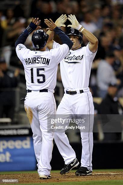 Scott Hairston is congratulated by his brother Jerry Hairston Jr. Of the San Diego Padres after hitting a home run against the Milwaukee Brewers at...