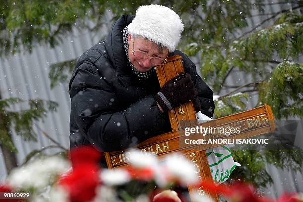 Serbian woman mourns at the grave of late Yugoslav President Slobodan Milosevic in the town of Pozarevac on March 11, 2010. Loyal supporters and...