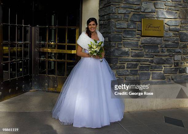 Woman in a white wedding gown arrives at the entrance to the Fairmont Banff Springs Hotel & Spa as seen in this 2010 Banff Springs, Canada, afternoon...