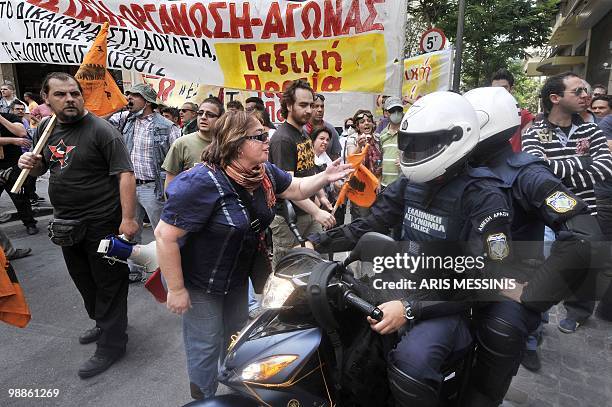 Woman argues with Greek riot policemen during clashes in the center of Athens on May 5, 2010. A nationwide general strike gripped Greece in the first...