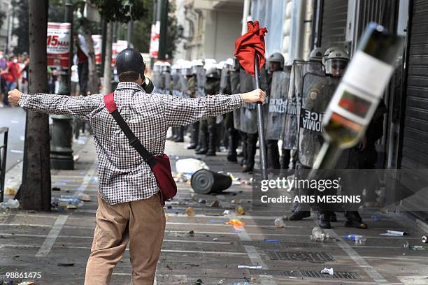 Protestor gestures at Greek riot police during clashes in the center of Athens on May 5, 2010. Athens police chiefs mobilized all their forces,...