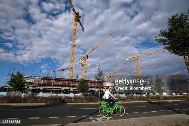 Construction cranes stand above the Europacity project residential building site in Berlin, Germany, on Wednesday, June 27, 2018. In a...