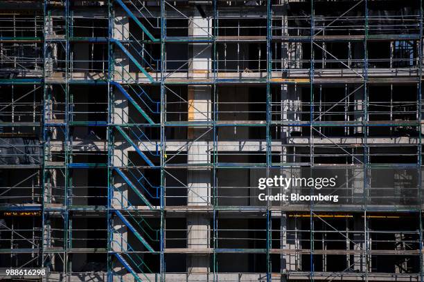 Scaffolding covers the Europacity project residential building site during ongoing construction work in Berlin, Germany, on Wednesday, June 27, 2018....