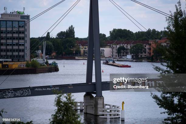 Cargo barge travels on the River Spree, seen from the roof terrace of an artist studio building on a new creative hub construction project in the...