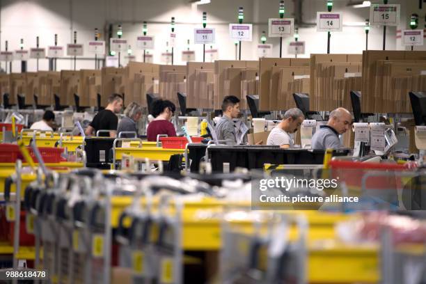 Employee ready mail order items for shipment during open media day of the electronic commerce giant Amazon, in Bad Hersfeld, Germany, 7 December...
