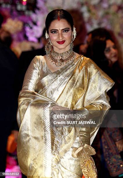 Indian Bollywood actress Rekha poses for a picture as she attends the pre-engagement party of India's richest man and Reliance Industries Limited...