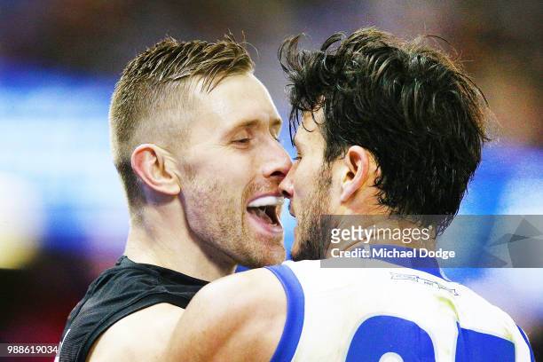 Shaun McKernan of Essendon mocks Robbie Tarrant of the Kangaroos after he fumbles a mark during the round 15 AFL match between the Essendon Bombers...