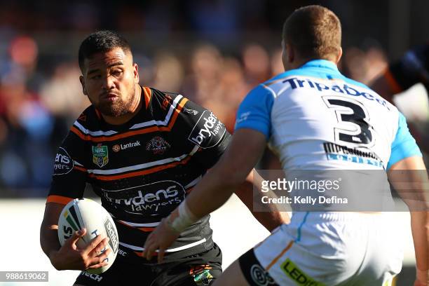 Esan Marsters of the Tigers runs with the ball during the round 16 NRL match between the Wests Tigers and the Gold Coast Titans at Leichhardt Oval on...