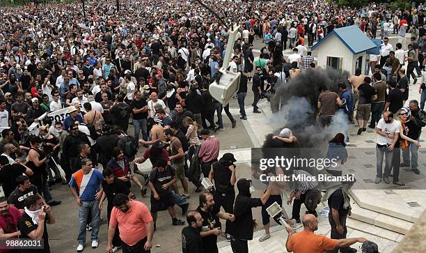 Protesters have tear gas deployed against them by Greek riot police outside parliament on May 5, 2010 in Athens, Greece. Three people have died after...