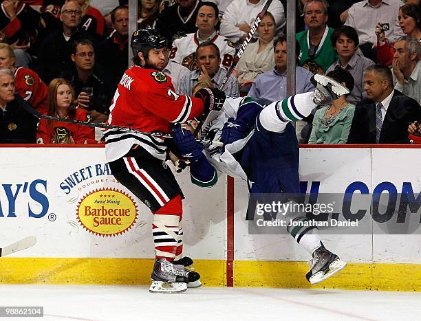 Brent Seabrook of the Chicago Blackhawks upends Jannik Hansen of the Vancouver Canucks in Game Two of the Western Conference Semifinals during the...