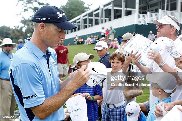 Jim Furyk signs his autograph for a patron during a practice round prior to the start of THE PLAYERS Championship held at THE PLAYERS Stadium course...