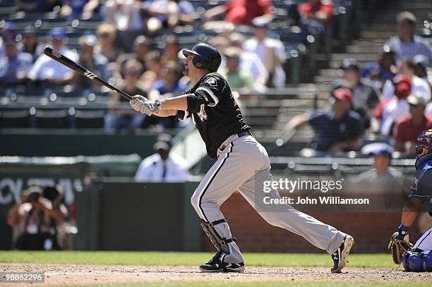 Paul Konerko of the Chicago White Sox bats and hits his second home run of the game and watches the ball as he runs to first base during the game...