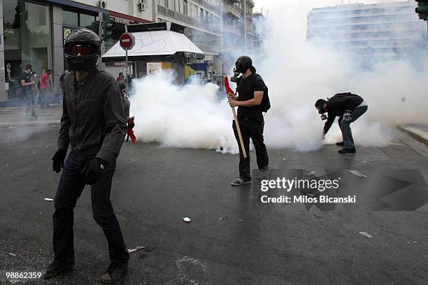 Protesters clash with Greek riot police outside parliament on May 5, 2010 in Athens, Greece. Three people have died after protesters set fire to the...