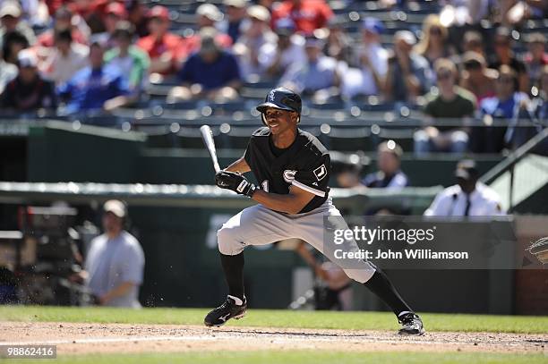 Juan Pierre of the Chicago White Sox bats and runs to first base after hitting the ball during the game against the Texas Rangers at Rangers Ballpark...