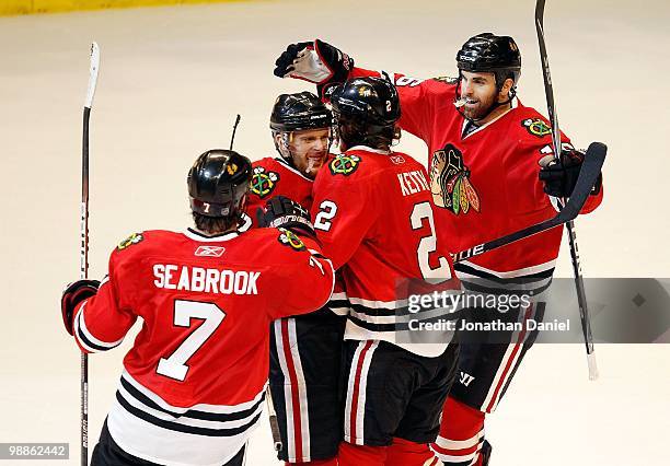 Brent Seabrook, Kris Versteeg, Duncan Keith and Andrew Ladd of the Chicago Blackhawks celebrate Versteegs' 3rd period goal against the Vancouver...