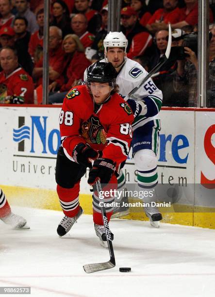 Patrick Kane of the Chicago Blackhawks reaches for the puck as Shane O'Brien of the Vancouver Canucks closes in in Game Two of the Western Conference...