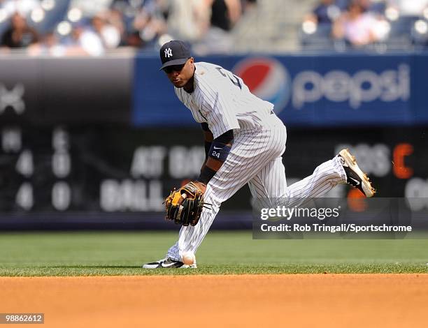 Robinson Cano of the New York Yankees attempts to field a ground ball against the Chicago White Sox at Yankee Stadium on May 01, 2010 in the Bronx...