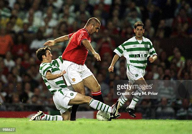 Eric Cantona of Man Utd clashes with Chris Sutton of Celtic during the Manchester United v Celtic Ryan Giggs Testimonial match at Old Trafford,...