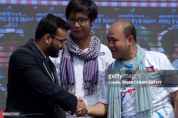 Swapnil Dangarikar , an adjudicator from the Guinness World Records, shakes hands with Hun Many , son of Cambodian Prime Minister Hun Sen, as Sann...