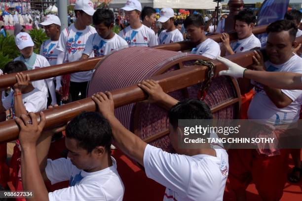 Cambodians carry a 1,149.8 metre-long krama scarf so it can be measured and judged as the world's longest hand woven scarf, in Phnom Penh on July 1,...