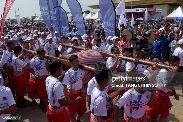 Cambodians carry a 1,149.8 metre-long krama scarf so it can be measured and judged as the world's longest hand woven scarf, in Phnom Penh on July 1,...