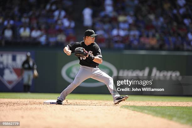 Second baseman Gordon Beckham of the Chicago White Sox fields his position as he throws to first base after catching a ground ball during the game...