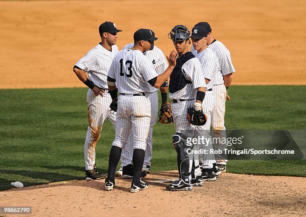 Alex Rodriguez of the New York Yankees stands on the mound with Derek Jeter, Jorge Posada and Joe Girardi against the Chicago White Sox at Yankee...