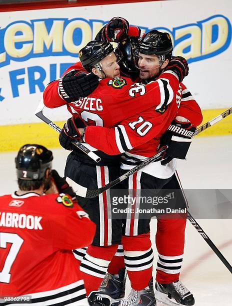 Brent Seabrook, Kris Versteeg, Andrew Ladd and Duncan Keith of the Chicago Blackhawks celebrate Versteegs' 3rd period goal against the Vancouver...