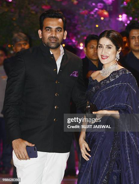 Indian Cricketer Zaheer Khan poses for a picture with his wife and actress Sagarika Ghatge as they attend the pre-engagement party of India's richest...